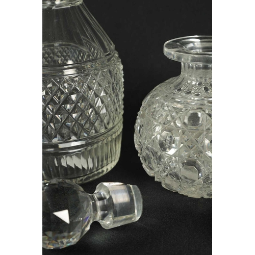 5 - A PAIR OF 19TH CENTURY CUT GLASS DECANTERS with bulls-eye stoppers, triple ringed necks and hobnail-... 