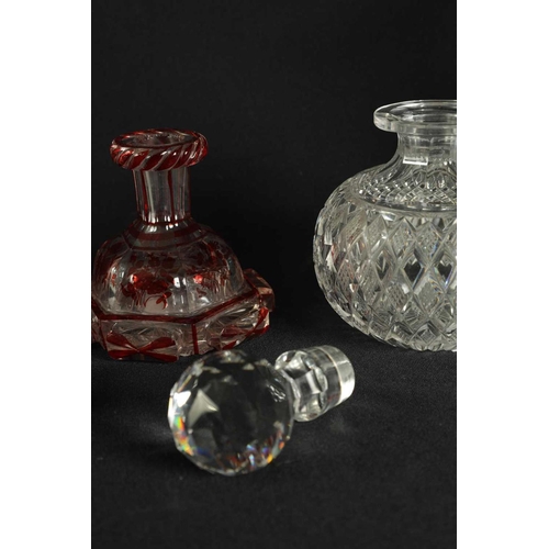 5 - A PAIR OF 19TH CENTURY CUT GLASS DECANTERS with bulls-eye stoppers, triple ringed necks and hobnail-... 