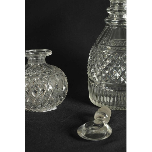 5 - A PAIR OF 19TH CENTURY CUT GLASS DECANTERS with bulls-eye stoppers, triple ringed necks and hobnail-... 