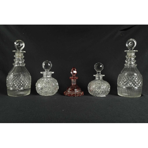 5 - A PAIR OF 19TH CENTURY CUT GLASS DECANTERS with bulls-eye stoppers, triple ringed necks and hobnail-... 