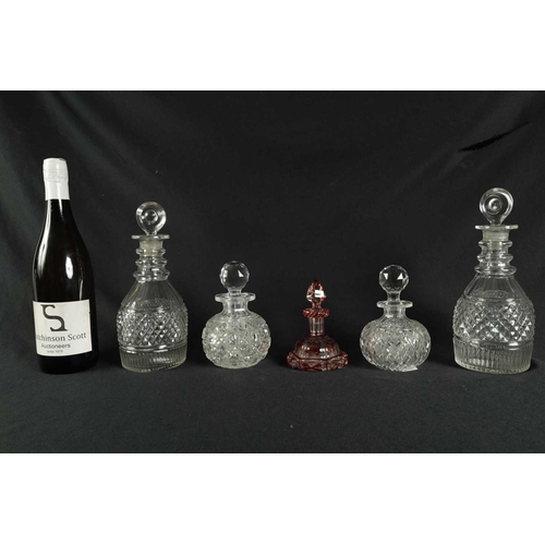 5 - A PAIR OF 19TH CENTURY CUT GLASS DECANTERS with bulls-eye stoppers, triple ringed necks and hobnail-... 