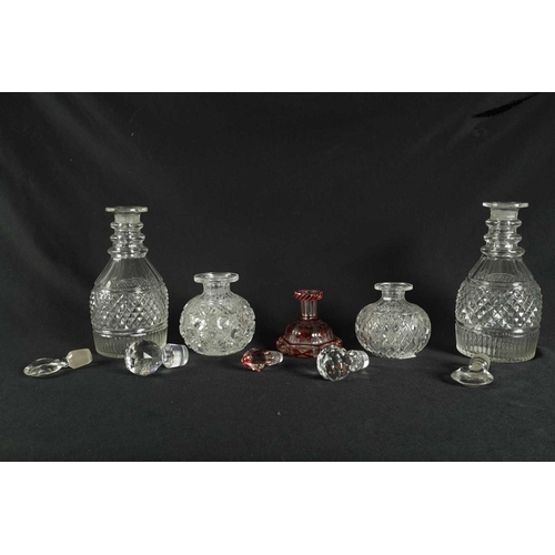 5 - A PAIR OF 19TH CENTURY CUT GLASS DECANTERS with bulls-eye stoppers, triple ringed necks and hobnail-... 