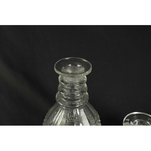 5 - A PAIR OF 19TH CENTURY CUT GLASS DECANTERS with bulls-eye stoppers, triple ringed necks and hobnail-... 