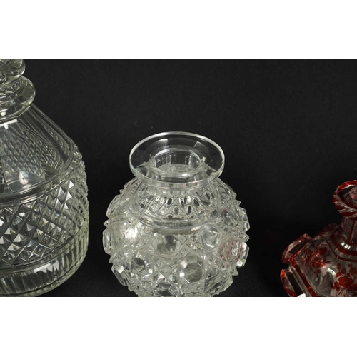 5 - A PAIR OF 19TH CENTURY CUT GLASS DECANTERS with bulls-eye stoppers, triple ringed necks and hobnail-... 