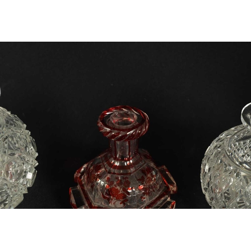 5 - A PAIR OF 19TH CENTURY CUT GLASS DECANTERS with bulls-eye stoppers, triple ringed necks and hobnail-... 