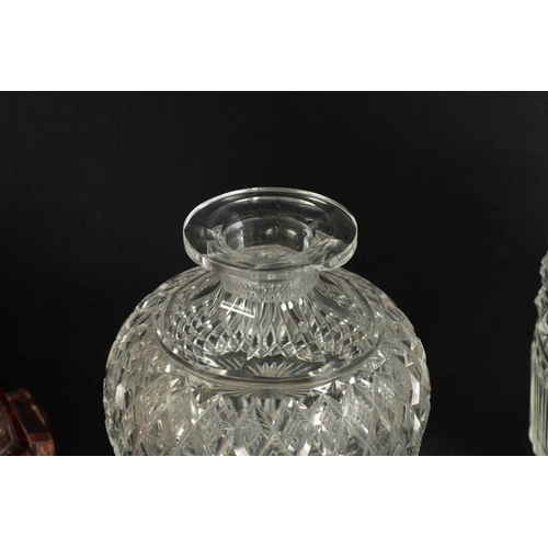 5 - A PAIR OF 19TH CENTURY CUT GLASS DECANTERS with bulls-eye stoppers, triple ringed necks and hobnail-... 