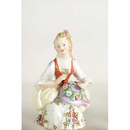 54 - A PAIR OF LATE 19TH CENTURY SITZENDORF PORCELAIN SEATED FIGURES depicting flower sellers dressed in ... 
