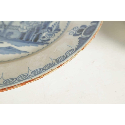 55 - AN 18TH-CENTURY DELFT BLUE AND WHITE PLATE with scrolled spired border enclosing a formal fenced gar... 