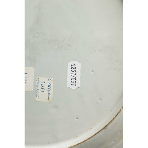 55 - AN 18TH-CENTURY DELFT BLUE AND WHITE PLATE with scrolled spired border enclosing a formal fenced gar... 
