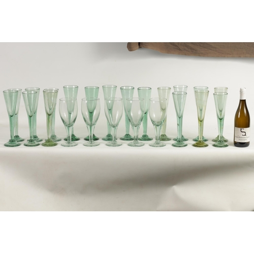 10 - A COLLECTION OF 19TH CENTURY GREEN WINE GLASSES comprising 18 fluted champagne flutes and five large... 