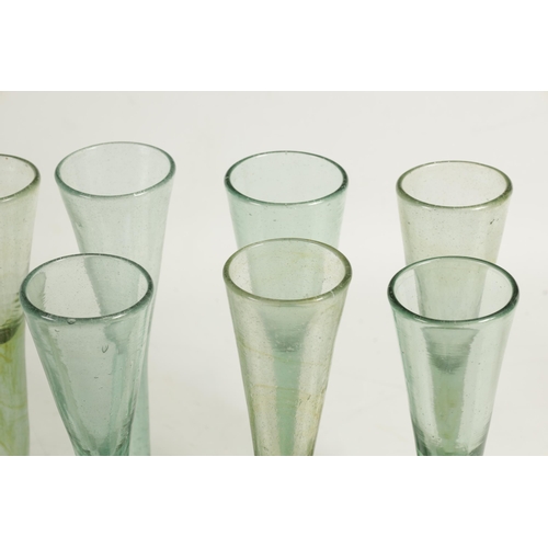 10 - A COLLECTION OF 19TH CENTURY GREEN WINE GLASSES comprising 18 fluted champagne flutes and five large... 