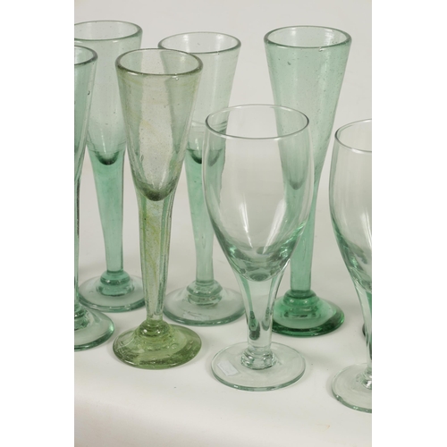 10 - A COLLECTION OF 19TH CENTURY GREEN WINE GLASSES comprising 18 fluted champagne flutes and five large... 