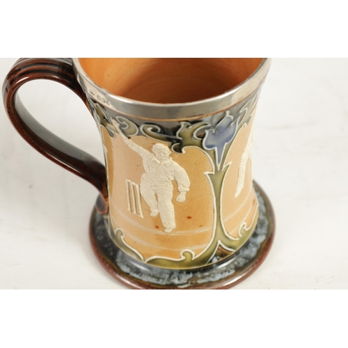 96 - A LATE 19TH CENTURY DOULTON LAMBETH STONEWARE CRICKET MUG with silver rim above a panelled body depi... 