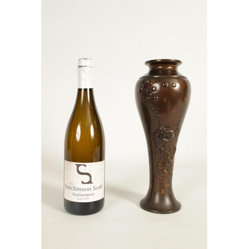 113 - A JAPANESE MEIJI PERIOD PATINATED BRONZE VASE of slender baluster form decorated with gilt masks to ... 