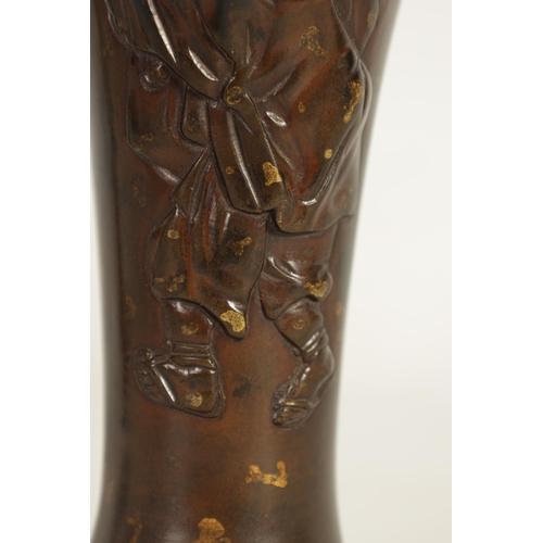 113 - A JAPANESE MEIJI PERIOD PATINATED BRONZE VASE of slender baluster form decorated with gilt masks to ... 