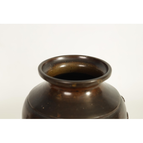 113 - A JAPANESE MEIJI PERIOD PATINATED BRONZE VASE of slender baluster form decorated with gilt masks to ... 