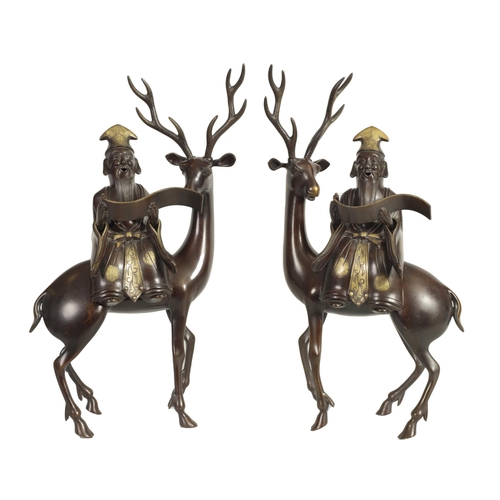 119 - A LARGE PAIR OF LATE 19TH CENTURY PATINATED BRONZE KOROS both modelled as a sage seated on a stag re... 