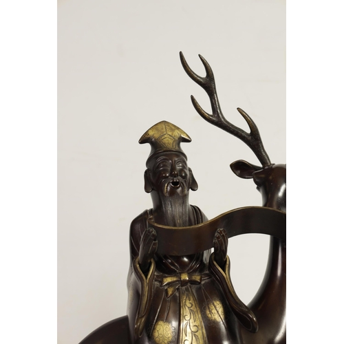 119 - A LARGE PAIR OF LATE 19TH CENTURY PATINATED BRONZE KOROS both modelled as a sage seated on a stag re... 