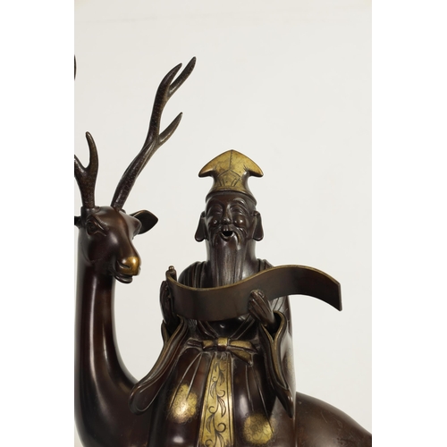 119 - A LARGE PAIR OF LATE 19TH CENTURY PATINATED BRONZE KOROS both modelled as a sage seated on a stag re... 