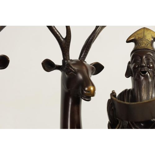 119 - A LARGE PAIR OF LATE 19TH CENTURY PATINATED BRONZE KOROS both modelled as a sage seated on a stag re... 