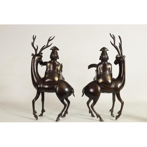 119 - A LARGE PAIR OF LATE 19TH CENTURY PATINATED BRONZE KOROS both modelled as a sage seated on a stag re... 