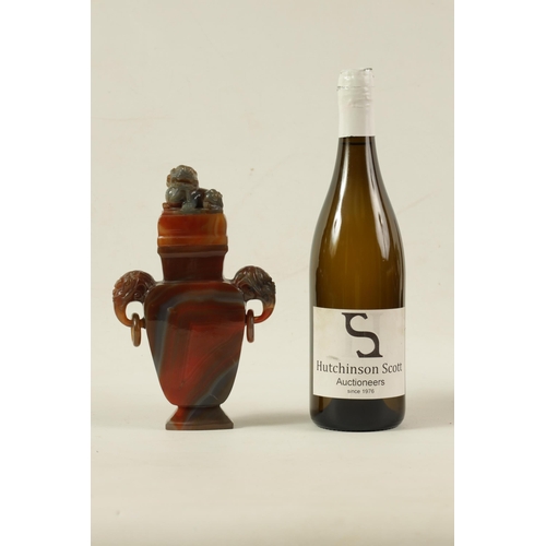 122 - A CHINESE CARVED CARNELIAN AGATE VASE AND COVER the lid carved with foo dog finial on a flattened ta... 