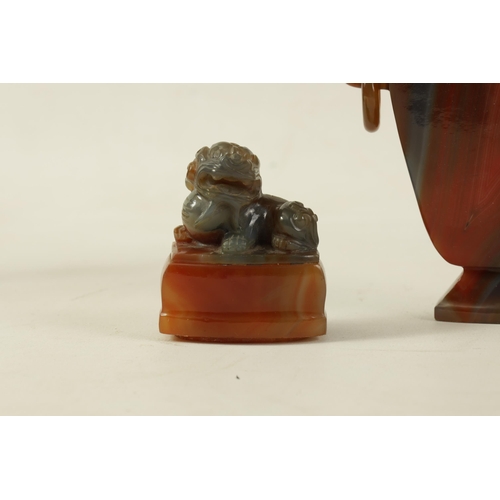 122 - A CHINESE CARVED CARNELIAN AGATE VASE AND COVER the lid carved with foo dog finial on a flattened ta... 