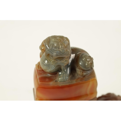 122 - A CHINESE CARVED CARNELIAN AGATE VASE AND COVER the lid carved with foo dog finial on a flattened ta... 