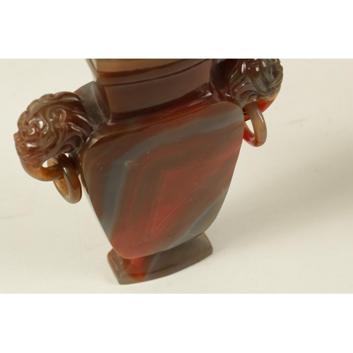 122 - A CHINESE CARVED CARNELIAN AGATE VASE AND COVER the lid carved with foo dog finial on a flattened ta... 