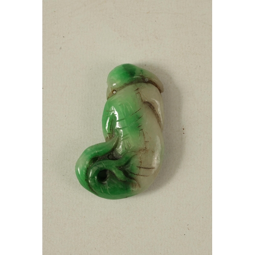 134 - A CHINESE TWO TONE CARVED JADE SCULPTURE modelled as a sage with fish tail (6cm high)