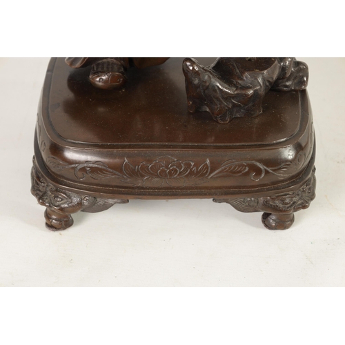 138 - A LARGE 19TH CENTURY CHINESE BRONZE RAKAN FIGURAL TABLE GONG depicted holding a large bowl gong; rai... 