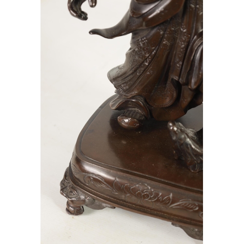 138 - A LARGE 19TH CENTURY CHINESE BRONZE RAKAN FIGURAL TABLE GONG depicted holding a large bowl gong; rai... 