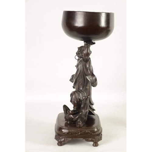 138 - A LARGE 19TH CENTURY CHINESE BRONZE RAKAN FIGURAL TABLE GONG depicted holding a large bowl gong; rai... 