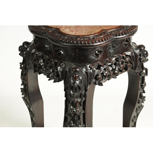 139 - A 19TH CENTURY CHINESE PROFUSELY CARVED HARDWOOD JARDINIERE STAND the lobed flowerhead and leaf-carv... 