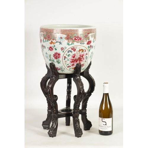 143 - A GOOD 19TH CENTURY CHINESE FAMILLE ROSE JARDINIERE ON CARVED HARDWOOD STAND the rounded body decora... 