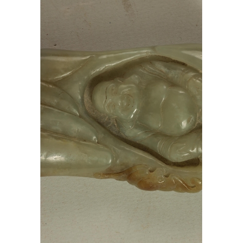 144 - A CHINESE CARVED JADE SCULPTURE modelled as a seated Buddha with russet inclusions to the top (10cm ... 
