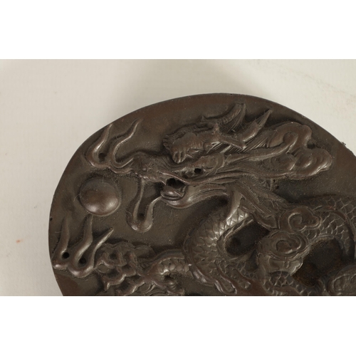 147 - A CHINESE DRAGON INKSTONE of shaped form with relief carved dragon amongst stylised clouds, Chinese ... 