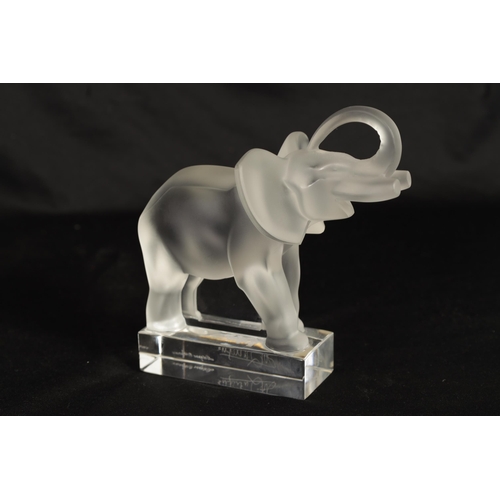 15 - A LALIQUE FROSTED GLASS ELEPHANT with raised trunk standing on a plinth base - with double signature... 