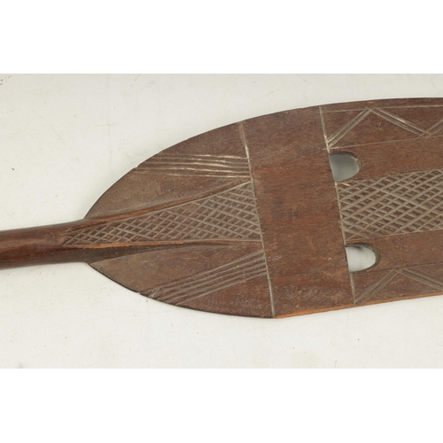 150 - A 19TH CENTURY AFRICAN HARDWOOD PADDLE with cross-hatched carved decoration (167cm overall)