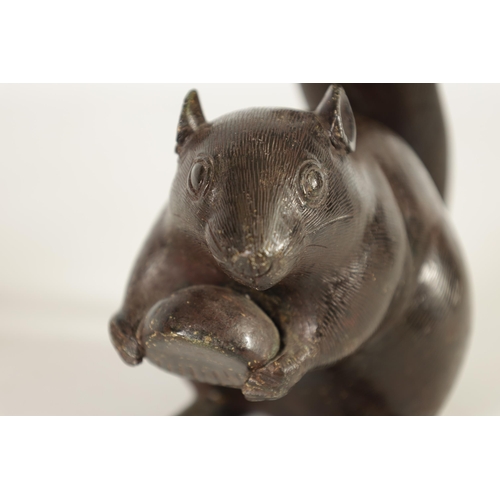 151 - A JAPANESE MEIJI PERIOD BRONZE SCULPTURE OF A RAT modelled holding a nut with an upright tail. (15.5... 