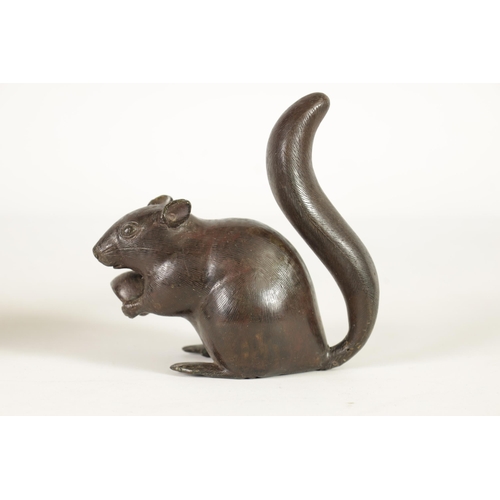 151 - A JAPANESE MEIJI PERIOD BRONZE SCULPTURE OF A RAT modelled holding a nut with an upright tail. (15.5... 