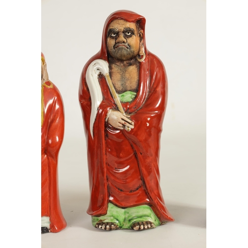 155 - TWO MEIJI PERIOD JAPANESE KUTANI PORCELAIN FIGURES OF DARUMA both dressed in red robes and holding f... 