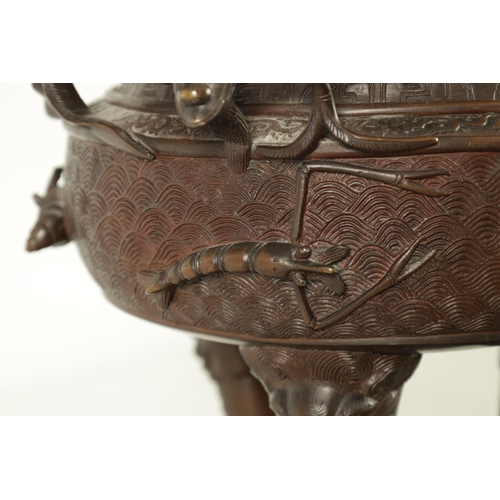 156 - A 19TH CENTURY CHINESE BRONZE CENSER AND LID MOUNTED ON A HARDWOOD STAND with pierced dragons head a... 