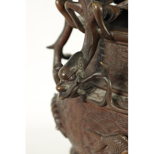 156 - A 19TH CENTURY CHINESE BRONZE CENSER AND LID MOUNTED ON A HARDWOOD STAND with pierced dragons head a... 