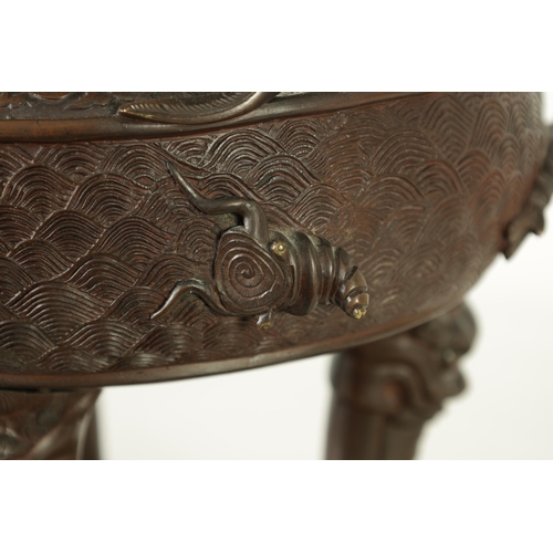 156 - A 19TH CENTURY CHINESE BRONZE CENSER AND LID MOUNTED ON A HARDWOOD STAND with pierced dragons head a... 