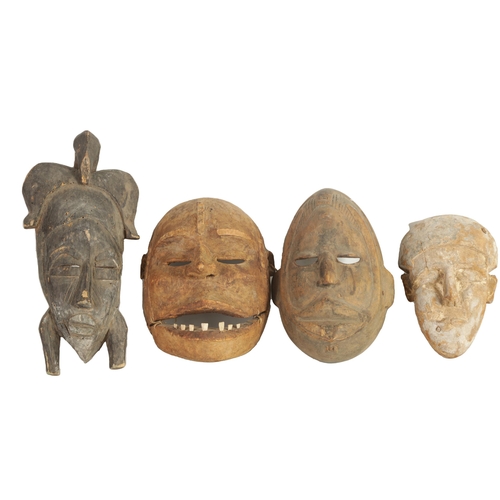 168 - A COLLECTION OF FOUR TRIBAL AFRICAN FACE MASKS one with teeth and moveable jaw. (28cm high and small... 