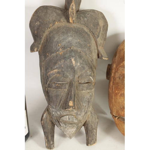 168 - A COLLECTION OF FOUR TRIBAL AFRICAN FACE MASKS one with teeth and moveable jaw. (28cm high and small... 