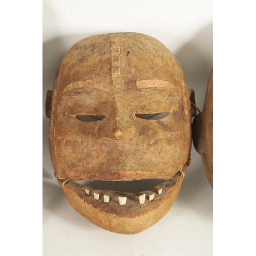 168 - A COLLECTION OF FOUR TRIBAL AFRICAN FACE MASKS one with teeth and moveable jaw. (28cm high and small... 