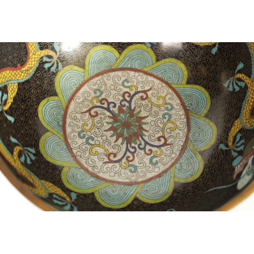 171 - A CHINESE CLOISONNE ENAMEL DRAGON BOWL decorated with five claw dragons amongst copper inlaid clouds... 