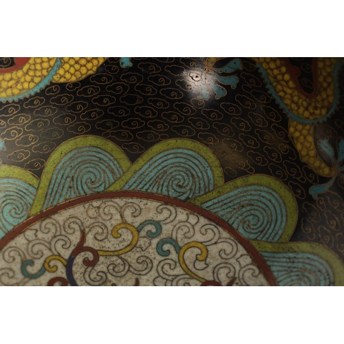 171 - A CHINESE CLOISONNE ENAMEL DRAGON BOWL decorated with five claw dragons amongst copper inlaid clouds... 